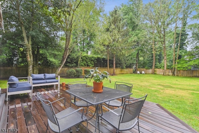 wooden terrace featuring an outdoor hangout area and a yard