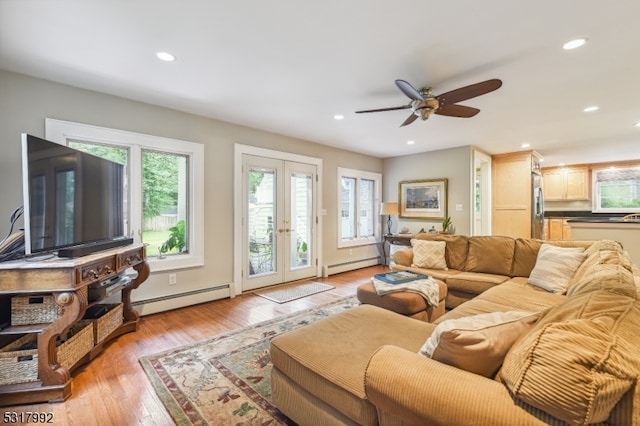 living room with light hardwood / wood-style flooring, ceiling fan, french doors, and baseboard heating