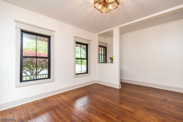 empty room with dark hardwood / wood-style flooring