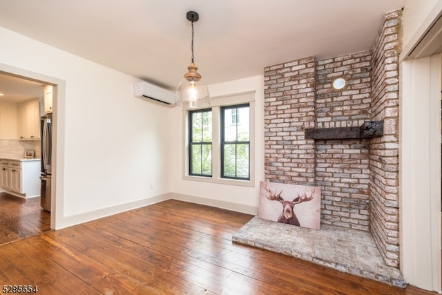 interior space with dark hardwood / wood-style floors and an AC wall unit