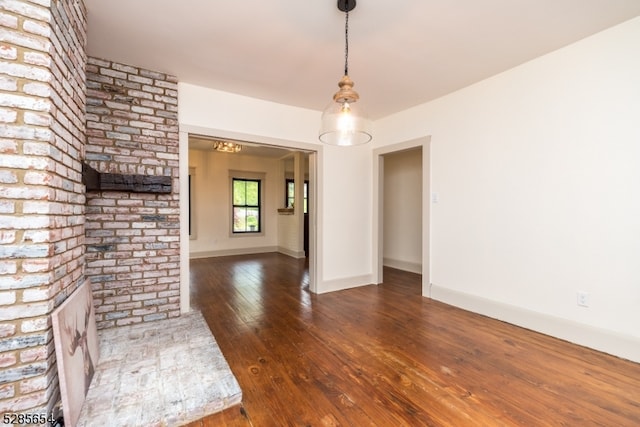 unfurnished living room with dark wood-type flooring