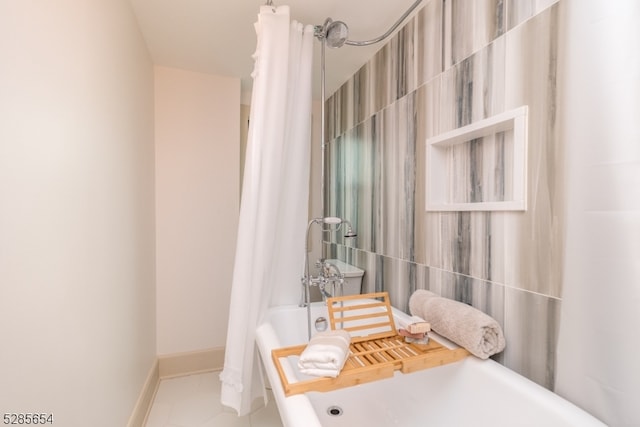 bathroom with tile walls, tile patterned flooring, and shower / tub combo with curtain