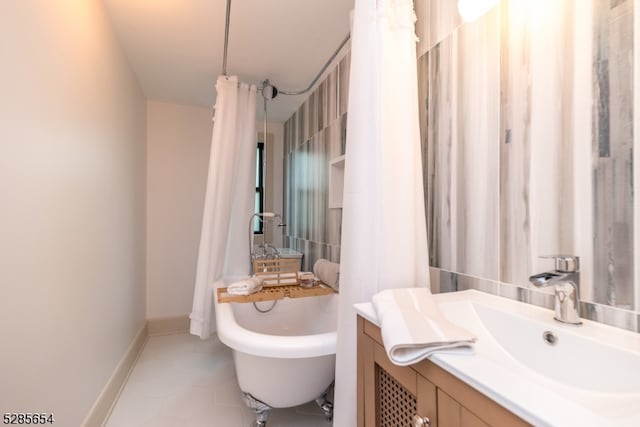 bathroom with a bathtub, tile patterned floors, and vanity