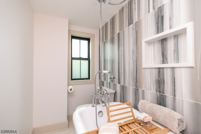 bathroom with tile walls and a tub