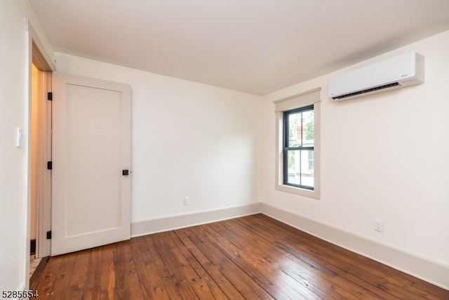 unfurnished room with wood-type flooring and a wall mounted AC