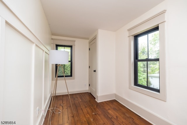 interior space with dark wood-type flooring and a healthy amount of sunlight