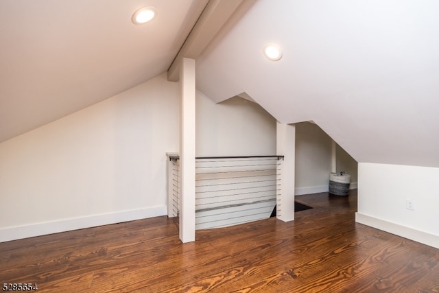 additional living space featuring lofted ceiling and dark hardwood / wood-style floors