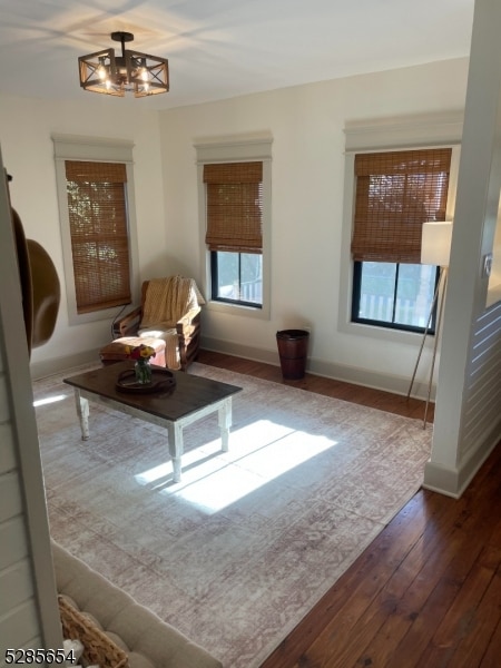 living area with a notable chandelier and wood-type flooring