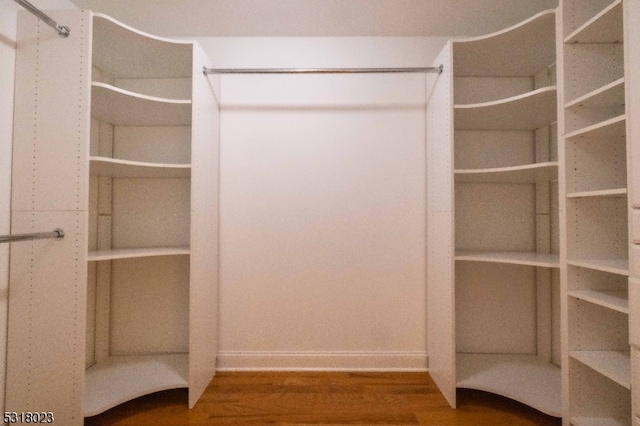 spacious closet featuring hardwood / wood-style floors