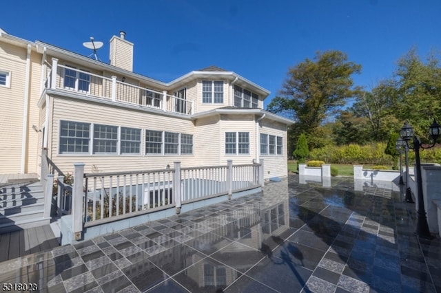 rear view of property featuring a patio area