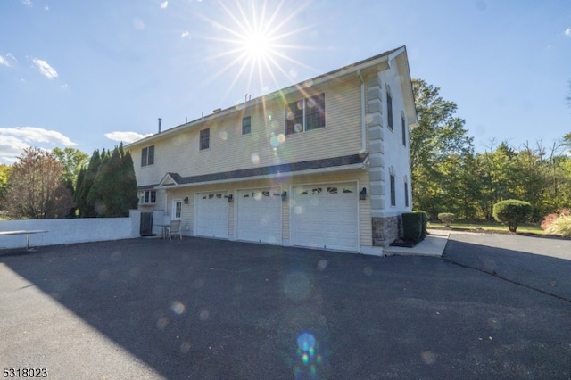 rear view of property with a garage