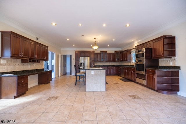 kitchen with crown molding, dark brown cabinets, a center island with sink, stainless steel appliances, and a kitchen bar