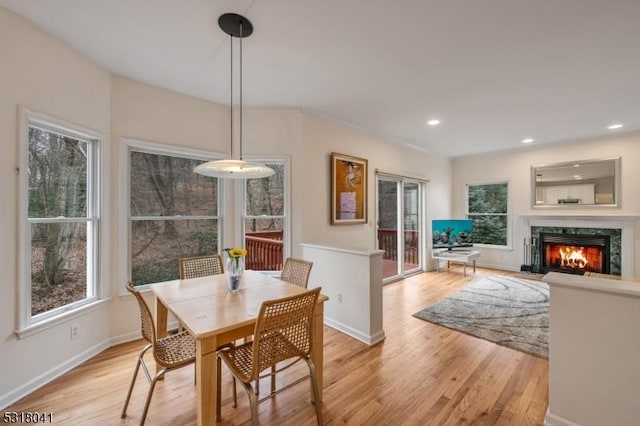 dining area with recessed lighting, a fireplace, light wood-style floors, and baseboards