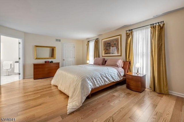 bedroom featuring light wood-style flooring, baseboards, and visible vents