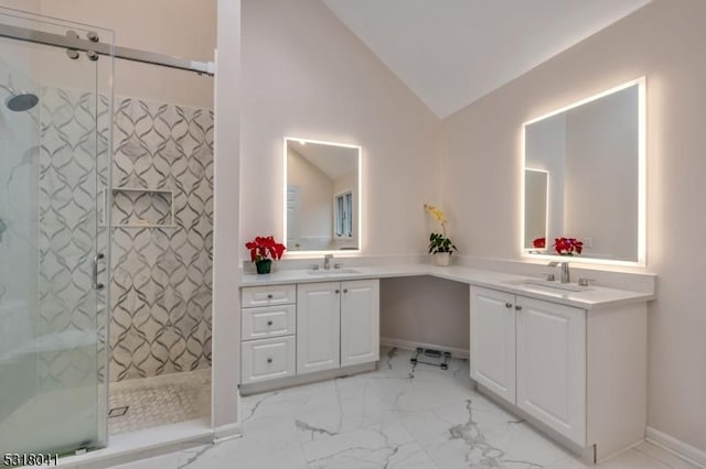 bathroom with vanity, a shower stall, marble finish floor, and vaulted ceiling