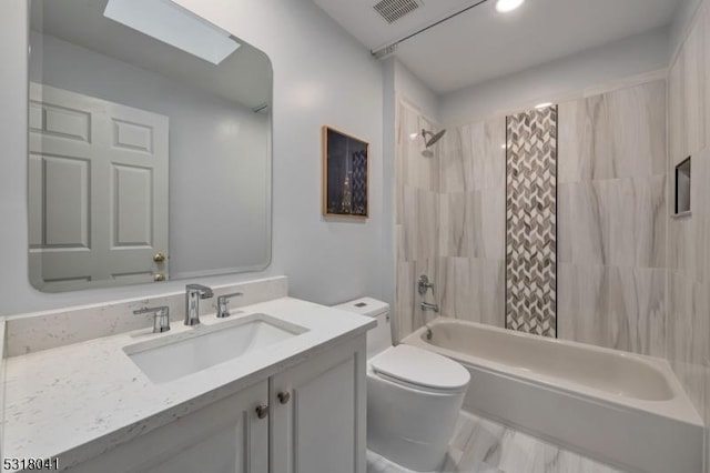 bathroom featuring visible vents, toilet, a skylight, shower / bath combination with curtain, and vanity