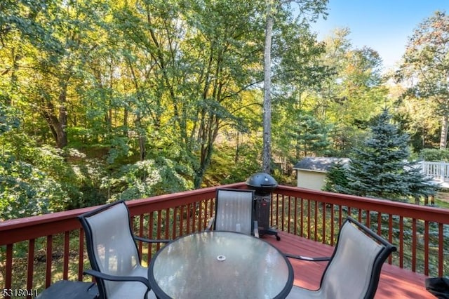 wooden terrace featuring outdoor dining area