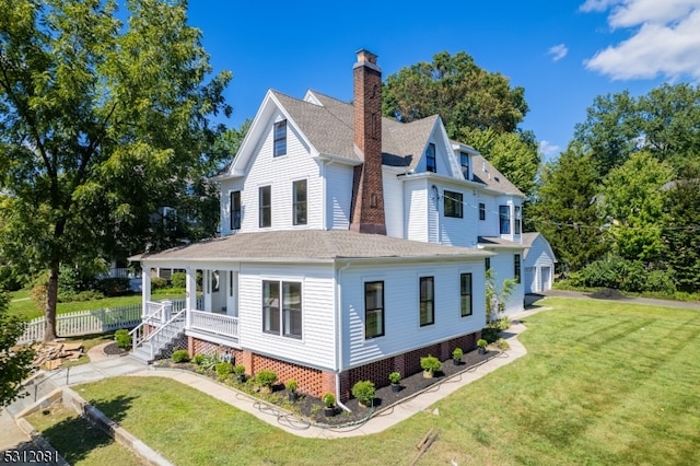 view of side of home featuring a lawn, a porch, and a garage