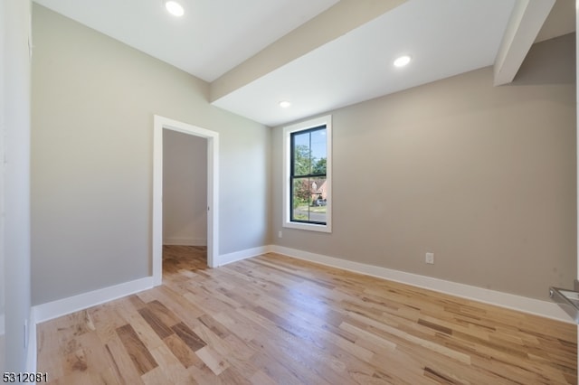 empty room with light hardwood / wood-style flooring