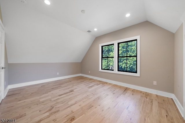 bonus room featuring light hardwood / wood-style flooring and lofted ceiling