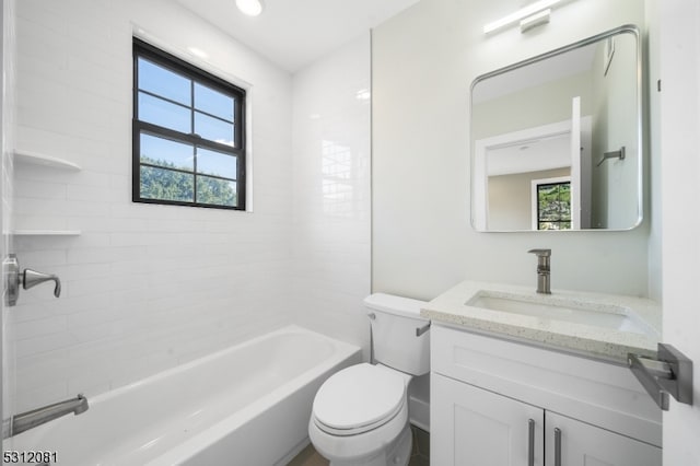 full bathroom featuring vanity, tiled shower / bath combo, and toilet