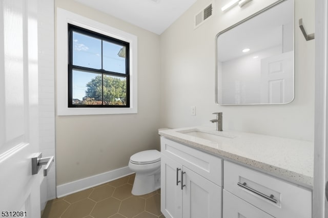 bathroom with tile patterned floors, vanity, and toilet