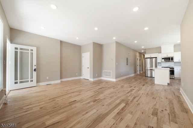 unfurnished living room featuring light wood-type flooring