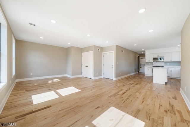 unfurnished living room featuring light wood-type flooring