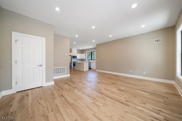 unfurnished living room with light wood-type flooring