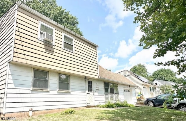 view of front of property featuring a front lawn and cooling unit