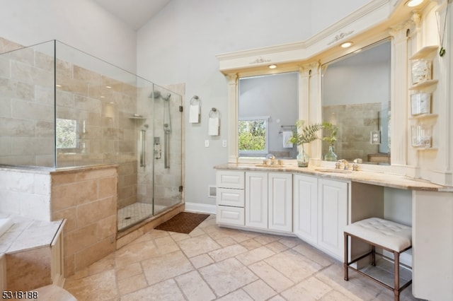 bathroom with vanity, a shower with shower door, and a high ceiling