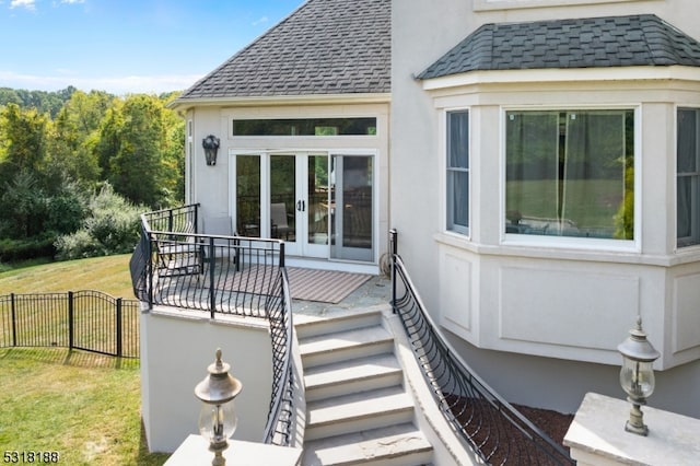 exterior space with french doors and a lawn