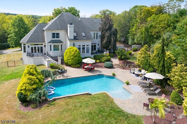 rear view of property with a patio area and a yard