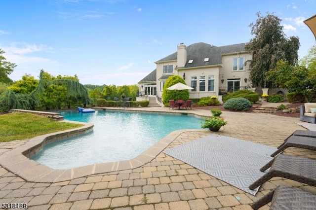 view of swimming pool with a patio area