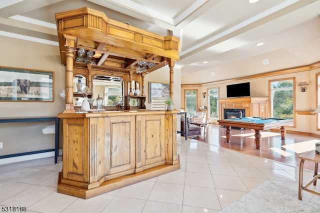 bar with light tile patterned flooring, ornate columns, crown molding, billiards, and light brown cabinets