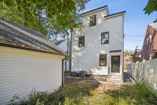 rear view of property with central air condition unit