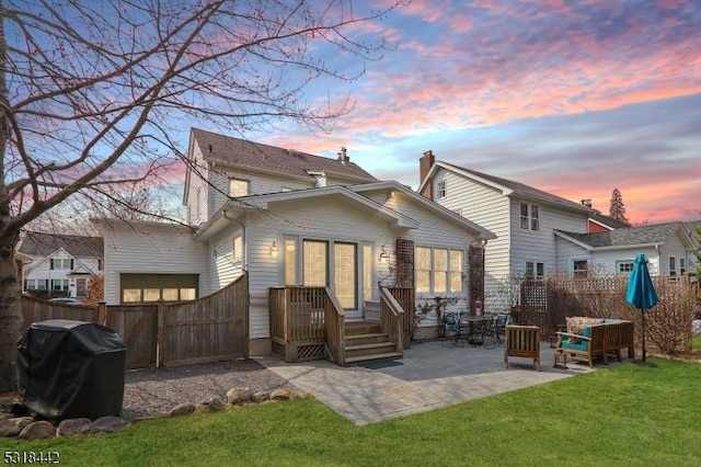 back of house with a yard, a patio, and fence