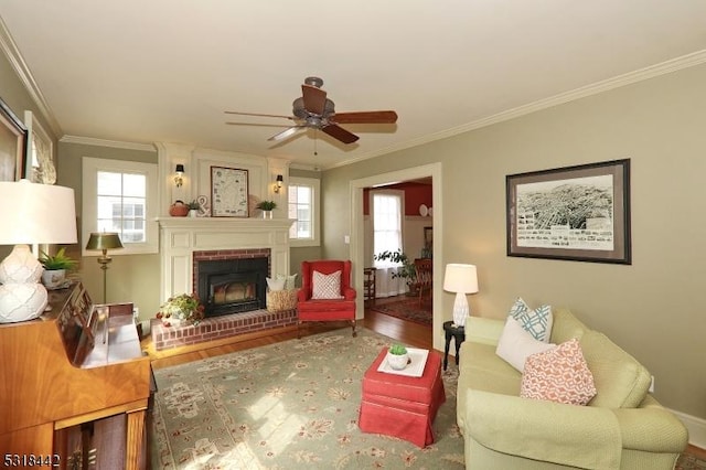 living area with a healthy amount of sunlight, wood finished floors, and crown molding