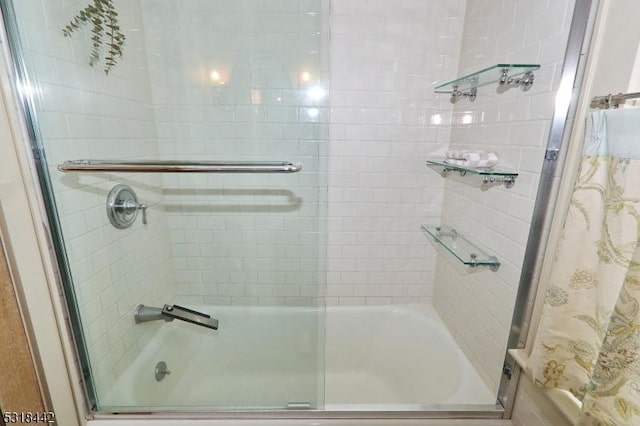 bathroom featuring shower / bath combination with glass door