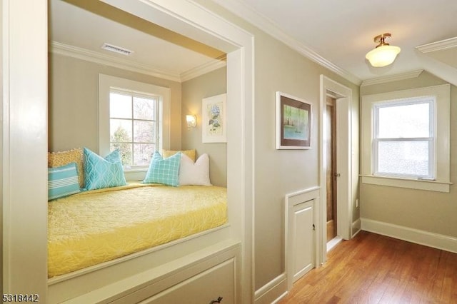 unfurnished bedroom featuring crown molding, baseboards, visible vents, and light wood finished floors