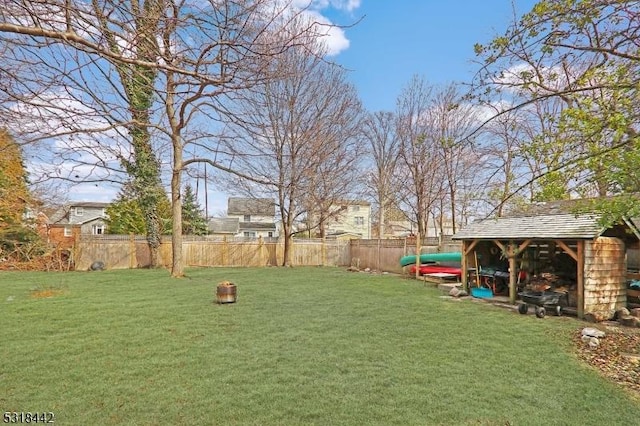 view of yard with an outdoor structure and fence