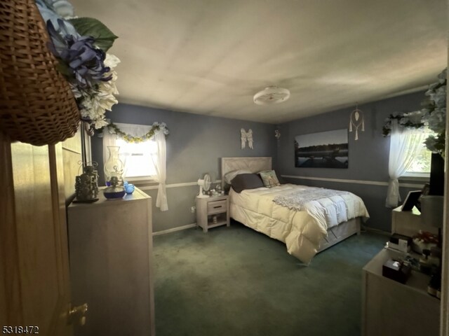 bedroom featuring carpet and baseboards