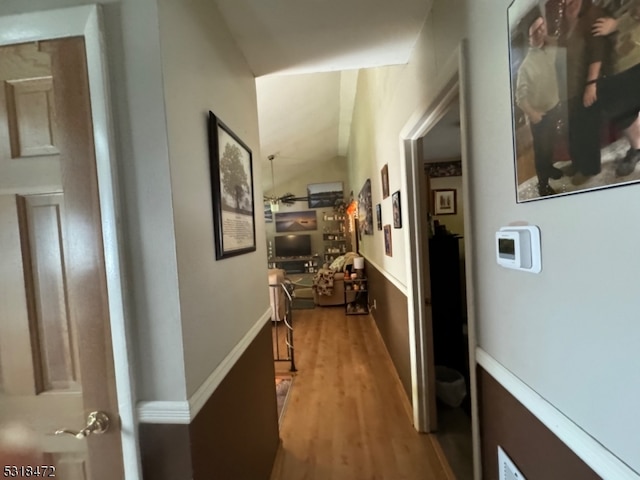 hallway with baseboards and wood finished floors