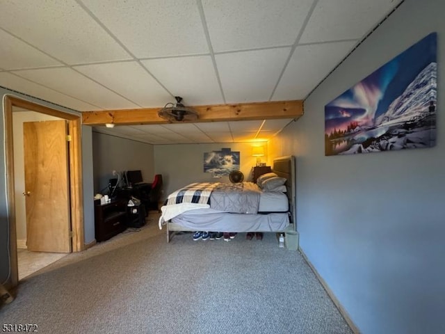 carpeted bedroom with a paneled ceiling