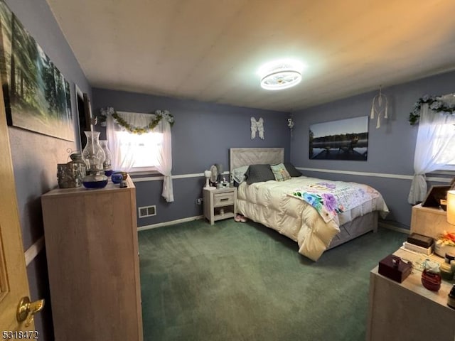 bedroom featuring carpet floors, visible vents, and baseboards