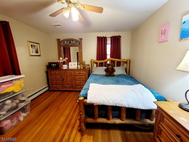 bedroom with wood-type flooring, ceiling fan, and a baseboard radiator