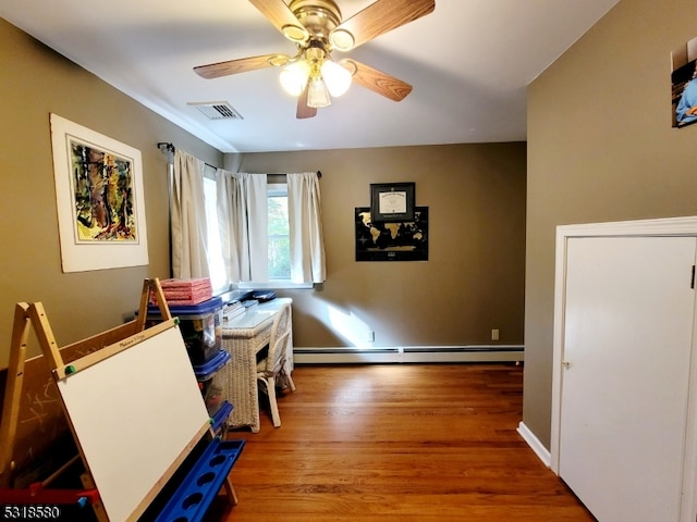 interior space with baseboard heating, hardwood / wood-style flooring, and ceiling fan