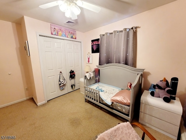 bedroom featuring a closet, light carpet, and ceiling fan