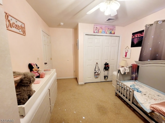 carpeted bedroom with a closet and ceiling fan