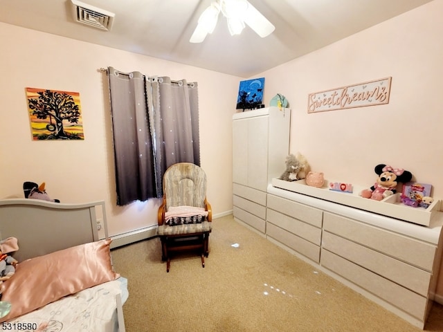 bedroom with carpet, ceiling fan, and a baseboard radiator